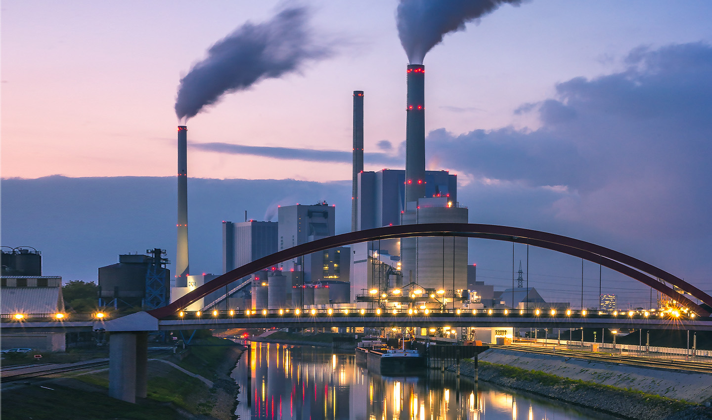 industry chimneys with smoke by a river